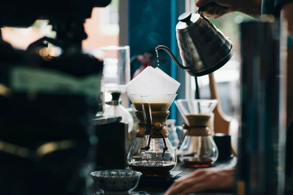 Pour-over coffee being prepared in a cafe
