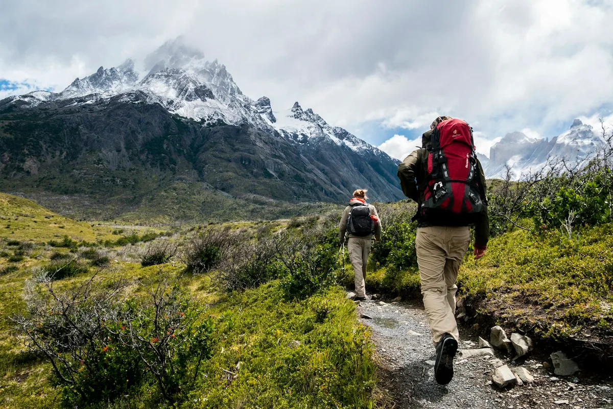 Hikers walking along a mountain trail